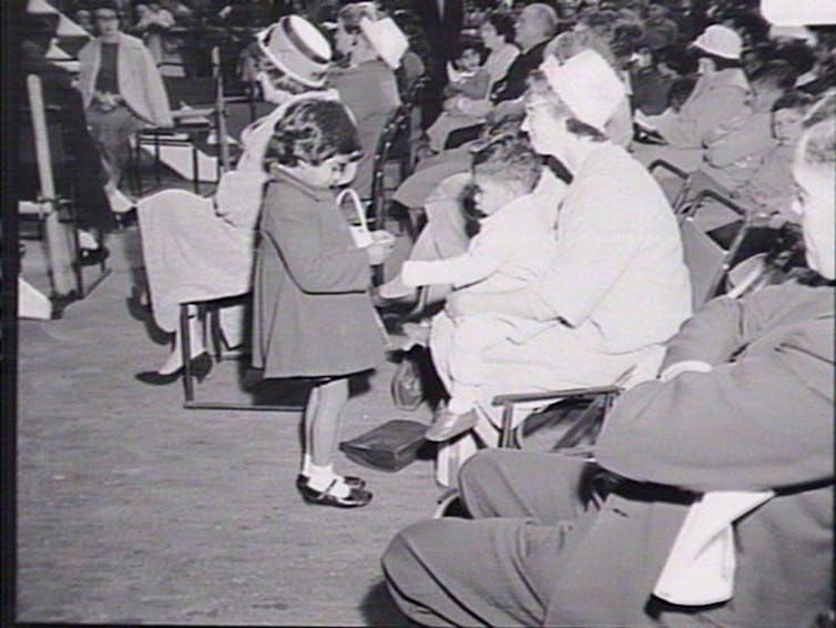 A young girl and a crowd.