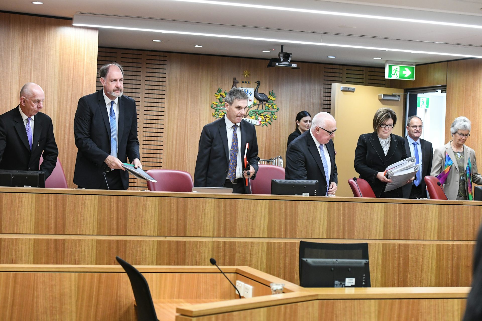 Men and women standing at a tribunal