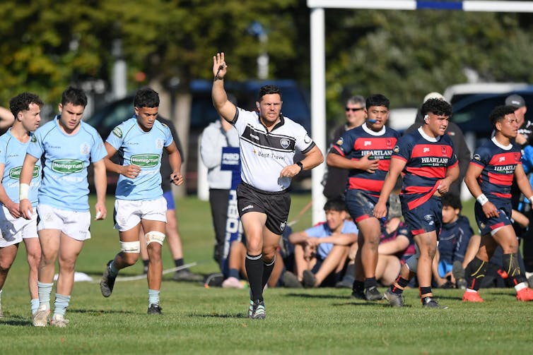 referee awarding try in schoolboy rugby game