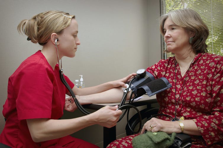 Nurse takes blood pressure