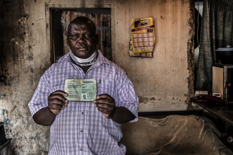 A man holding an ID book