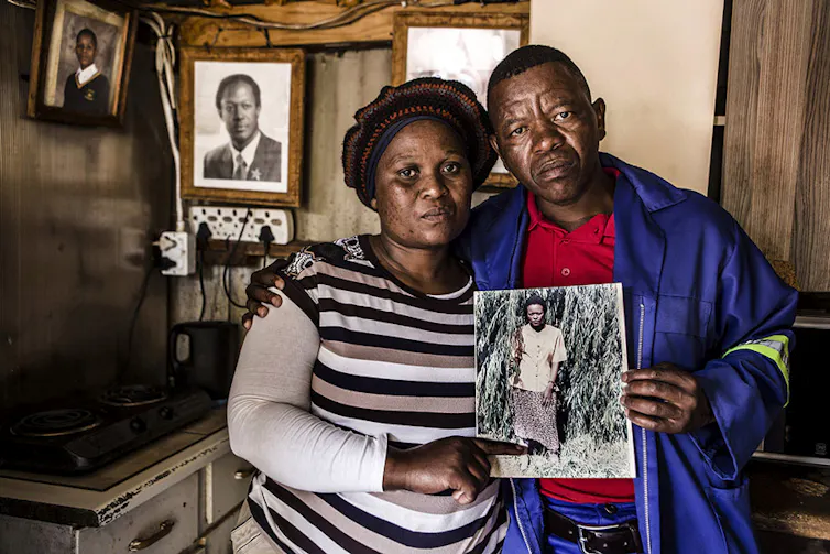 two people holding photograph