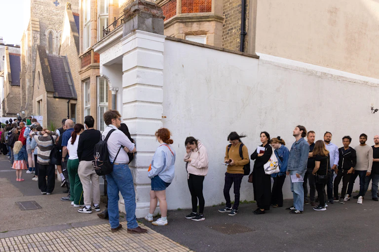 Queue of people going round a corner