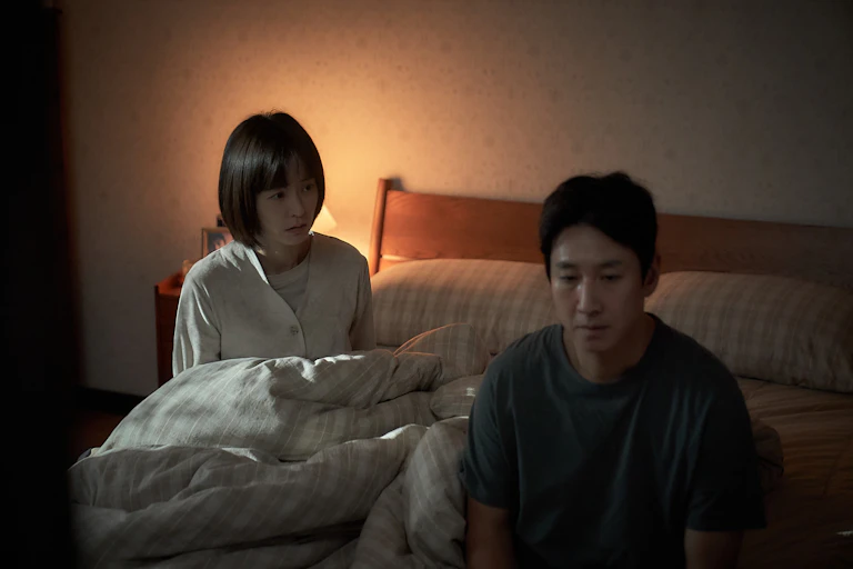 A husband and wife in bed.