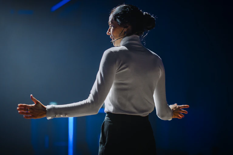 rear view of a woman addressing an audience