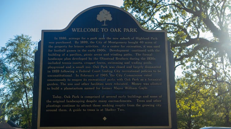 A marker describes the history of Oak Park, including a 1959 federal court ruling 'finding City recreational policies to be unconstitutional.'
