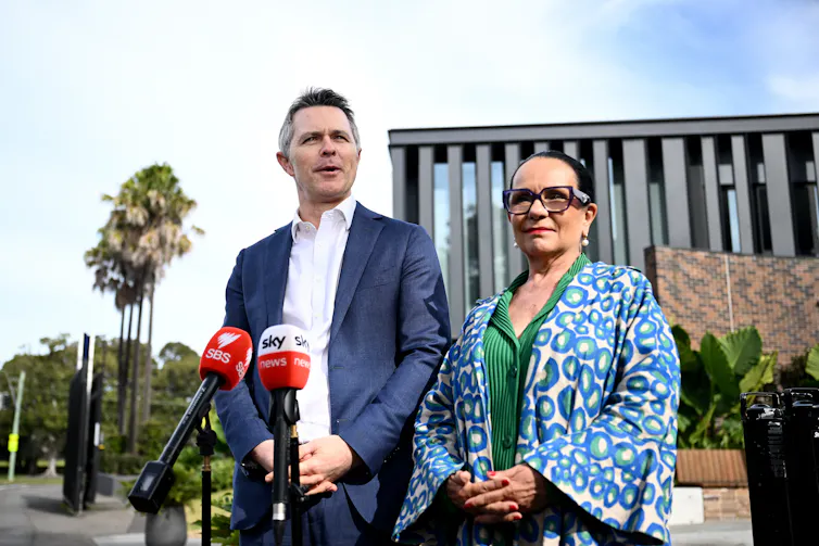 Education Minister Jason Clare and Minister for Indigenous Australians Linda Burney stand in front of microphones.