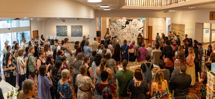 A big crowd in a gallery.