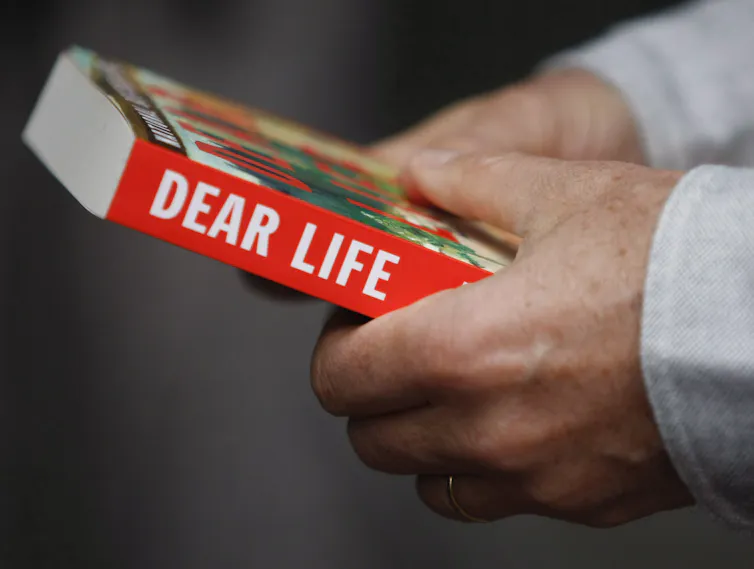 Hands hold a book.