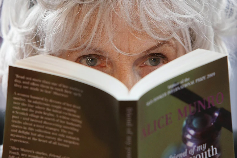 A woman's eyes seen behind a book.