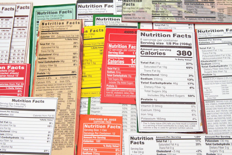 Various Nutrition Facts labels layered on a flat surface