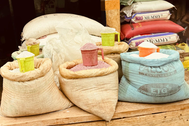 Open bags of grain sit on a wooden table