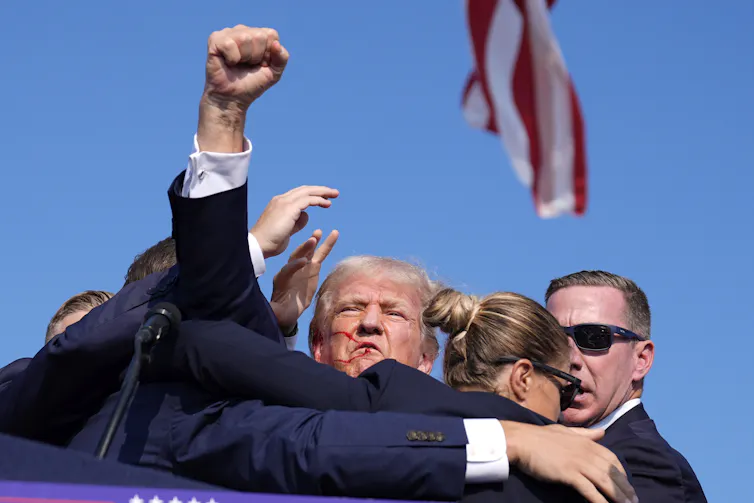 Trump raises a fist.