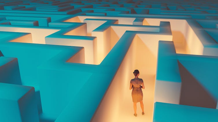 A human figure stands in the middle of a maze with many unclear passages.