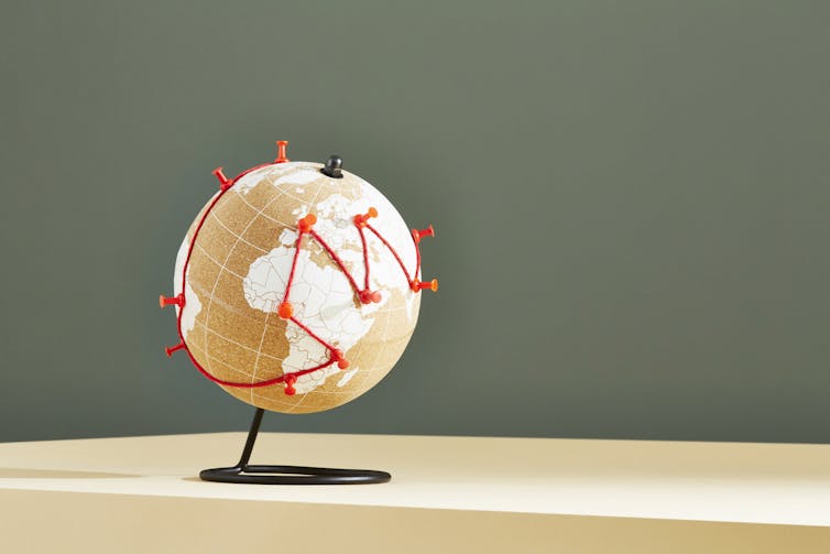 A line of red jumps around the world, fixed at particular places by pushpins.