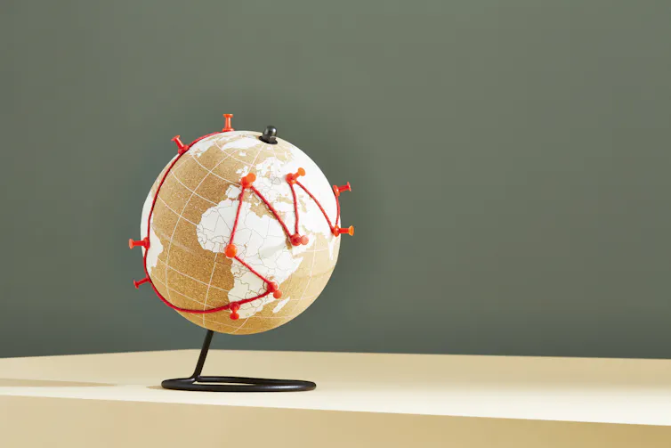 A line of red jumps around the world, fixed at particular places by pushpins.