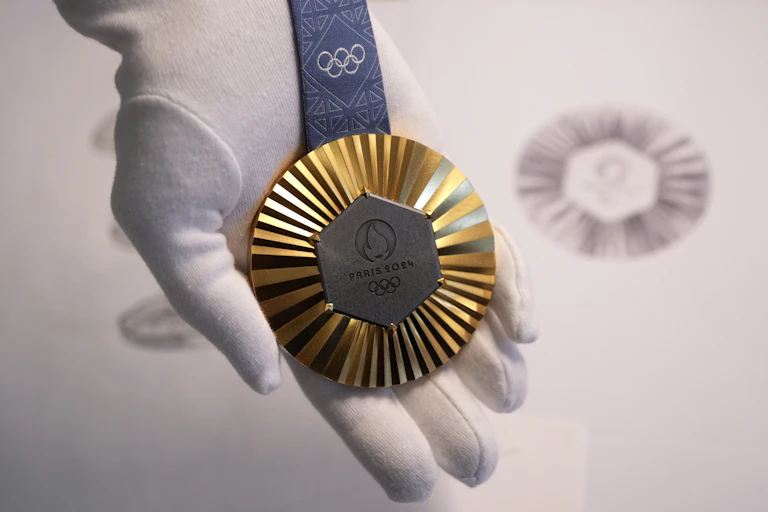 The Paris 2024 Olympic gold medal. A hexagonal, polished piece of iron taken from the Eiffel Tower is being embedded in each gold, silver and bronze medal that will be hung around athletes' neck