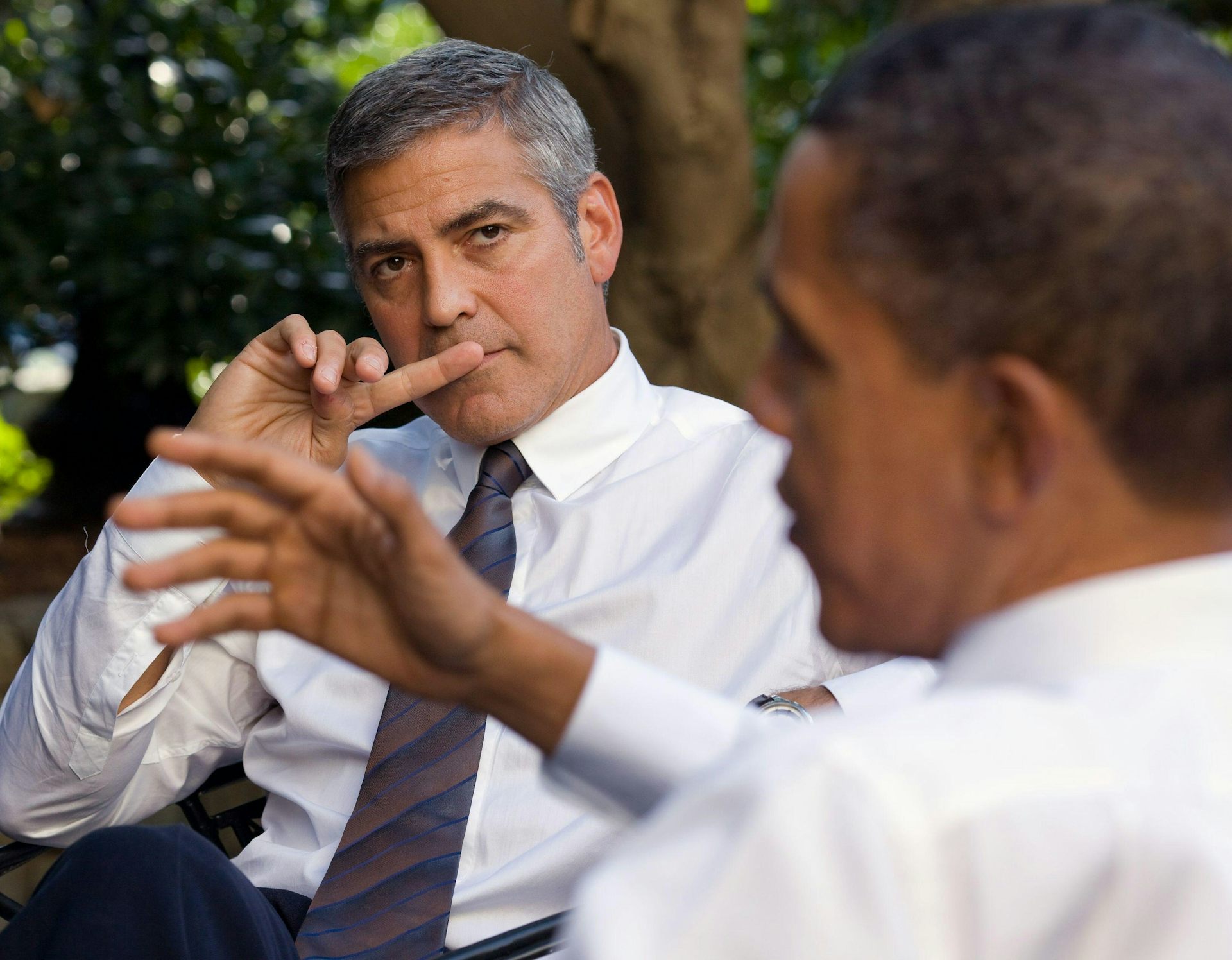 George Clooney looking at Barack Obama as he's mid speech.