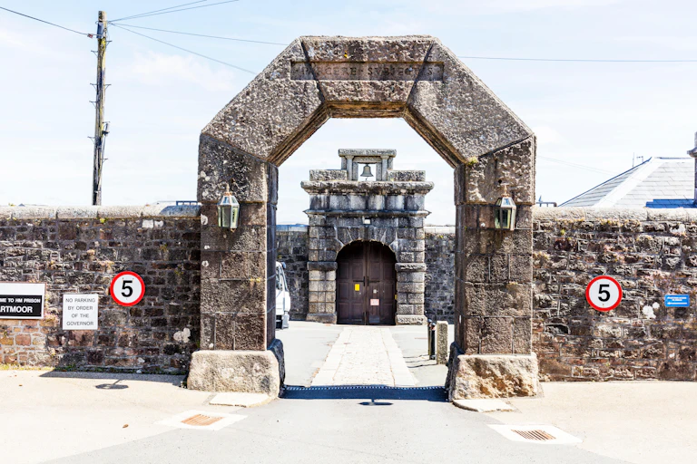 Entrance to Dartmoor prison, a Victorian-era stone gate and wall