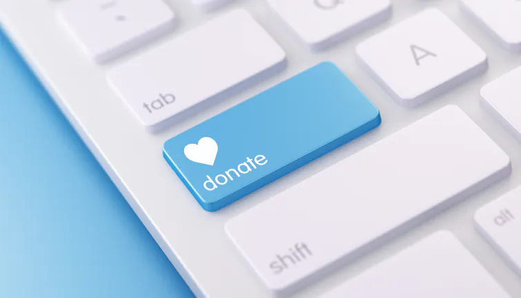 A modern white keyboard with blue colored Donate button.