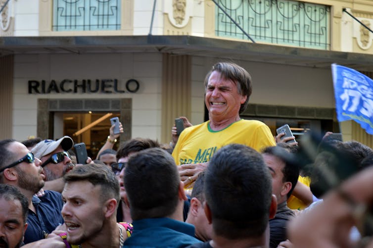 Jair Bolsonaro reacts after being stabbed.