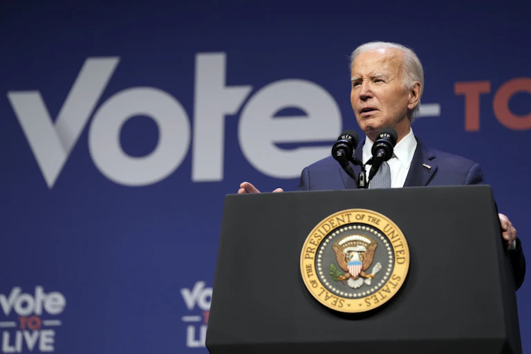 President Biden speaking on a podium.