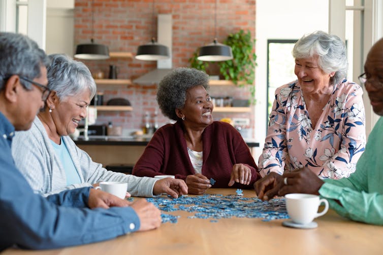 A group of older adults doing a puzzle.