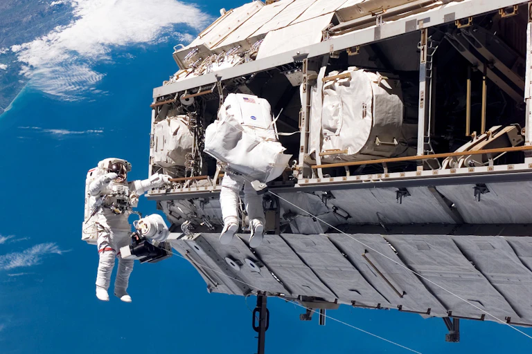 Astronauts participate in a spacewalk during construction of the International Space Station