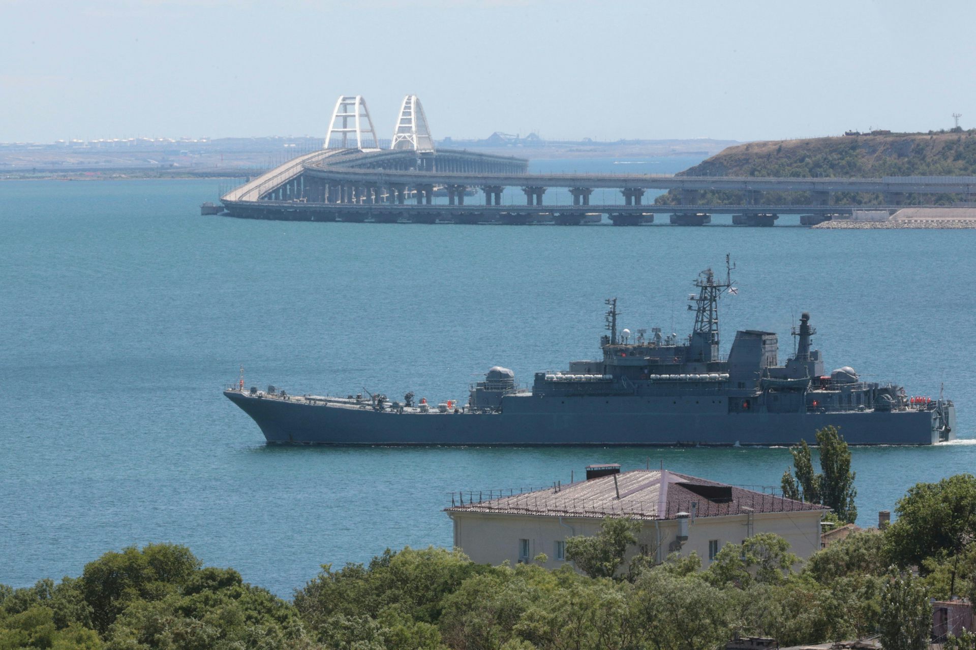 A Russian warship with the Kerch Bridge in the background, July 2023.