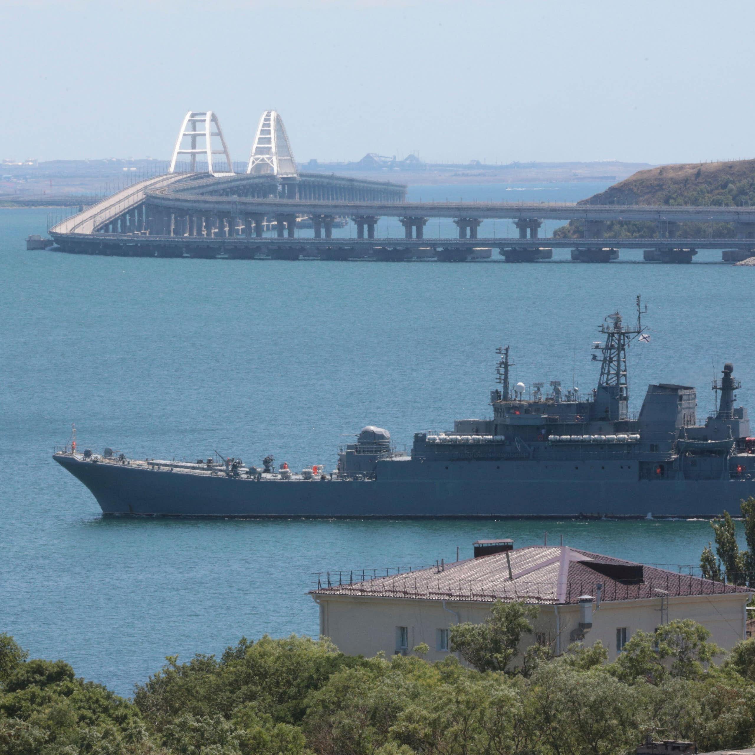 A Russian warship with the Kerch Bridge in the background, July 2023.
