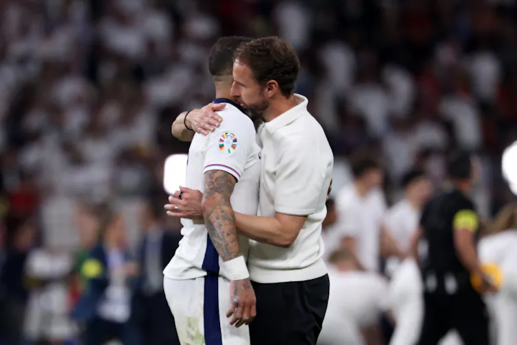 Gareth Southgate hugs England player Kyle Walker.