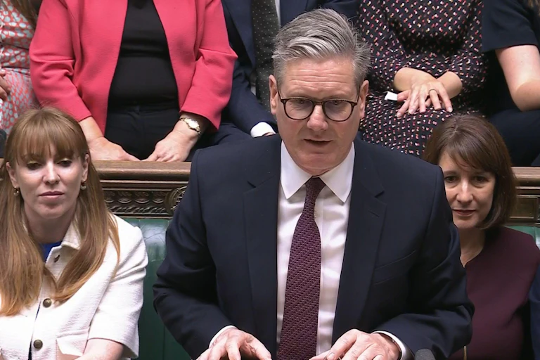 Close up of Keir Starmer with MPs sitting in background