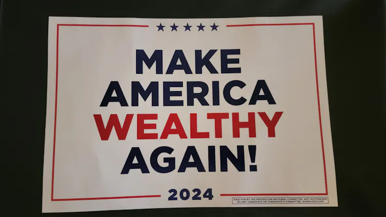 A red, white and blue sign that says 'MAKE AMERICA WEALTHY AGAIN! 2024'