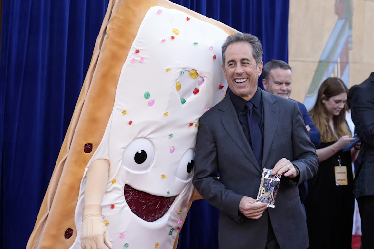 Jerry Seinfeld stands next to a frosted Pop-Tart mascot.
