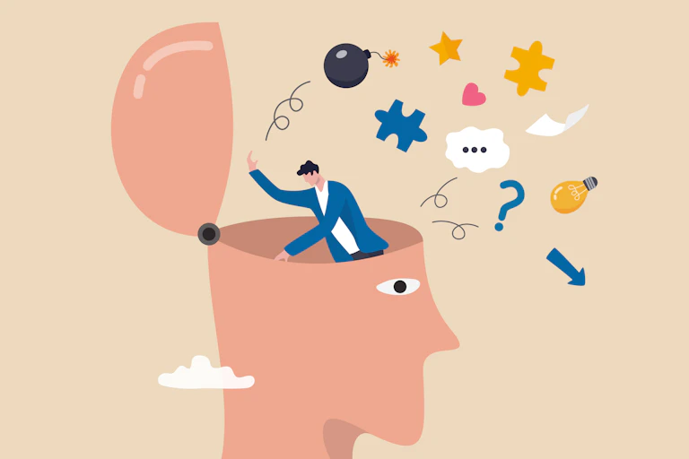 An illustration of a man standing in and digging through a human head that has opened on a hinge. He tosses out symbols like a bomb, puzzle piece and lightbulb.