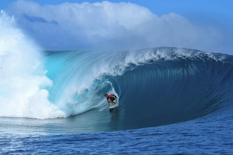Surfer riding big wave