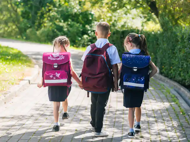 Three children walking to school