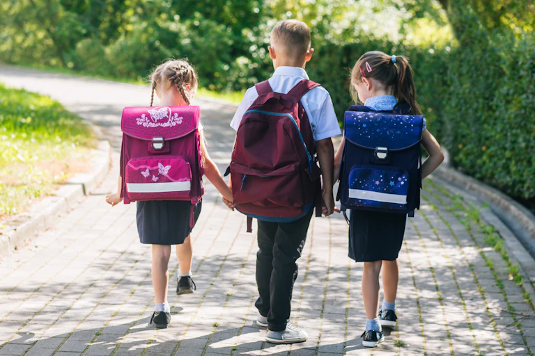 Three children walking to school