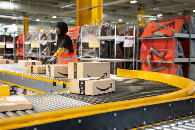 staff member on the conveyor belt at an Amazon warehouse