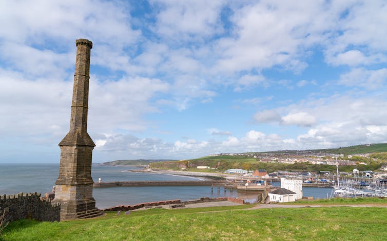 Tall chimney on coastal cliff