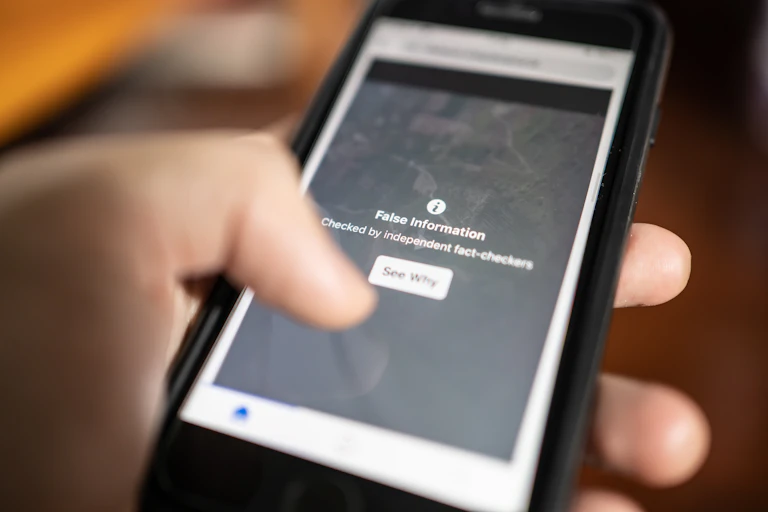 A smartphone with a notification with the words: false information