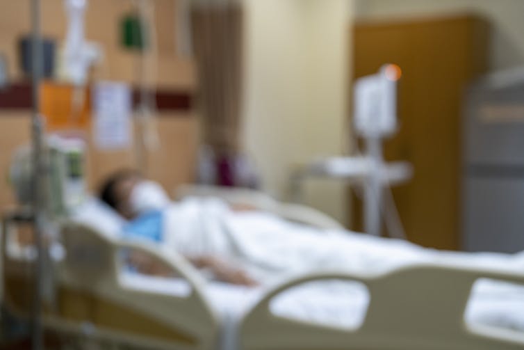 Out of focus image of hospital patient on drip