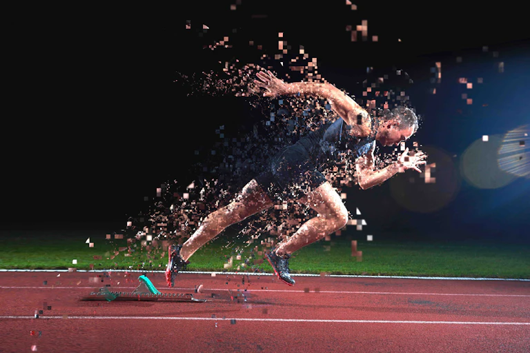 Photo of a sprinter taking off from the starting block amid a cloud of pixels.