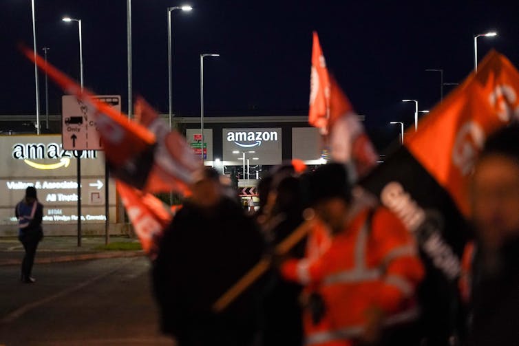 Gmb members waving flags outside Amazon's Coventry site