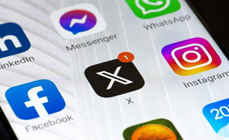 Close up of a phone screen displaying social media app icons