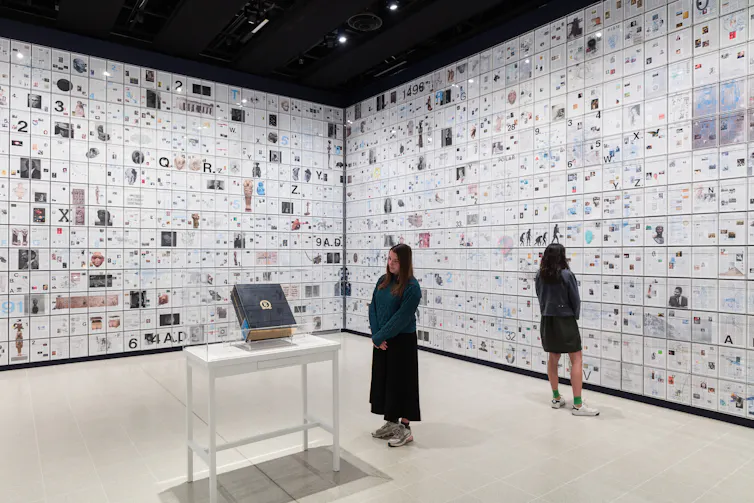 room containing pages of a book on the walls