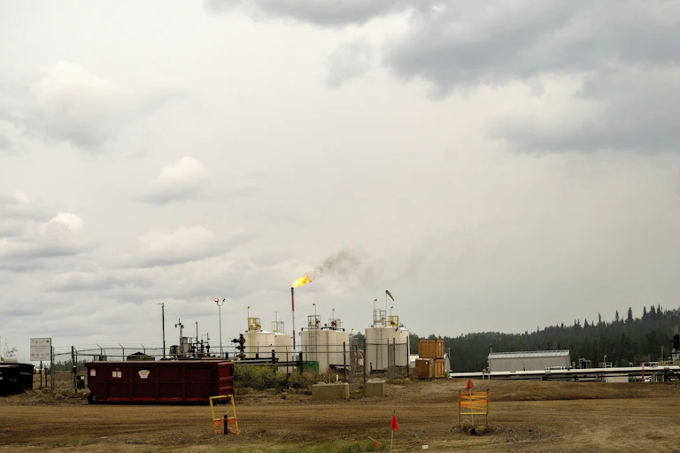 Flames rise out of a smokestack in a gas plant.