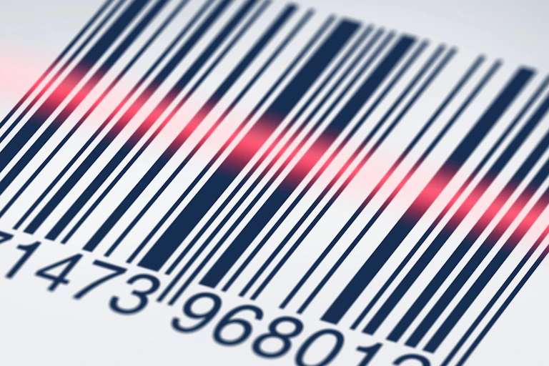 A bar code is seen in close-up as it is scanned.