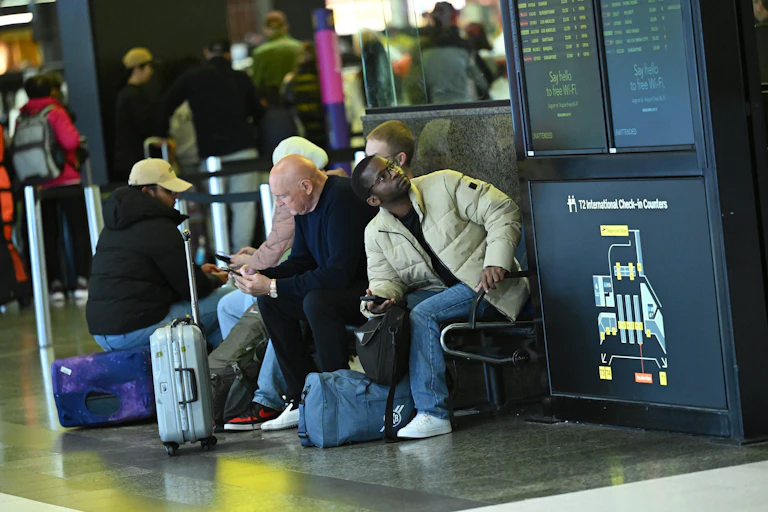 Travellers are seen waiting within the International departures terminal at Melbourne Airport