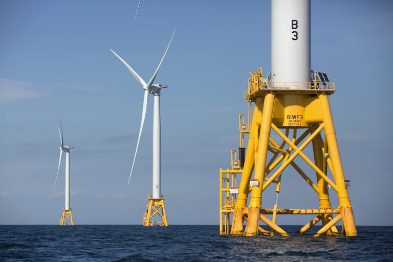 Three wind turbines on yellow bases, part of the Deepwater Wind project off Block Island, R.I.
